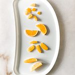 baby tray with oranges cut different ways for baby led weaning.