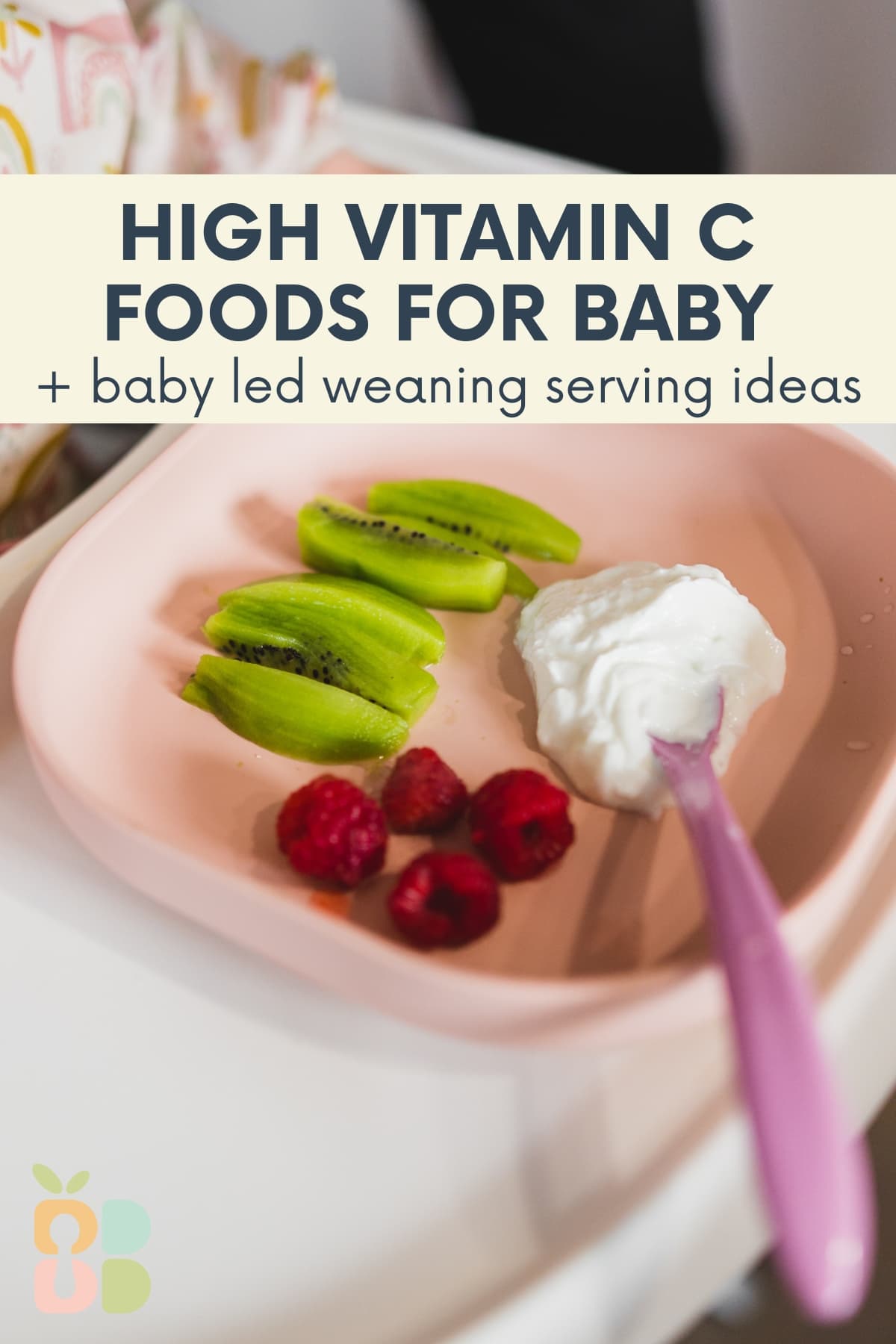 pink baby plate with kiwi, raspberries and yogurt on a high chair tray with text overlay.