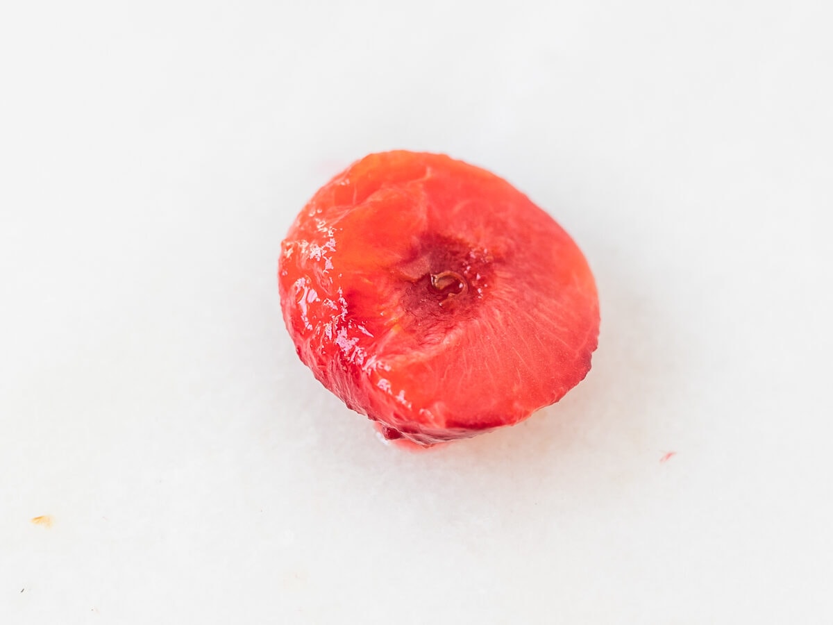 stewed plum half on a white background.