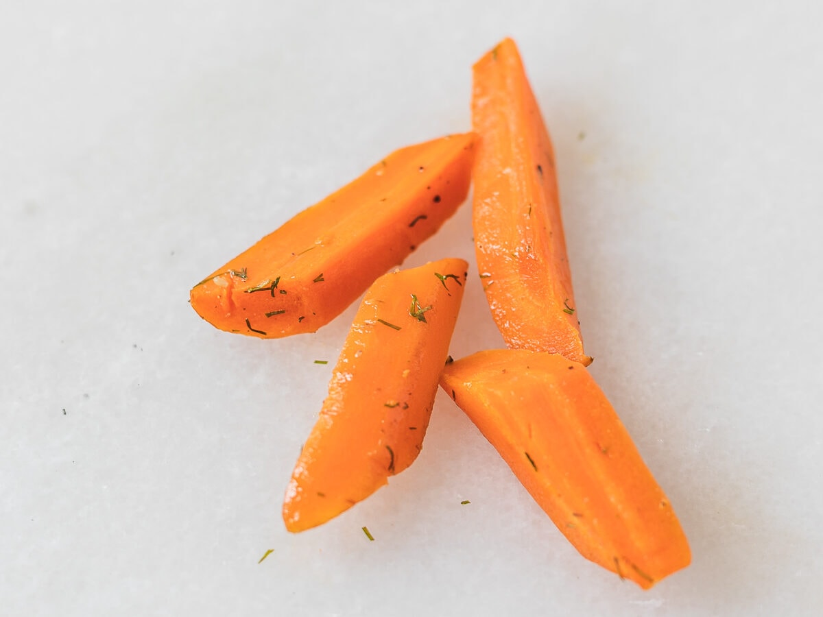 cooked carrot pieces tossed with dill.