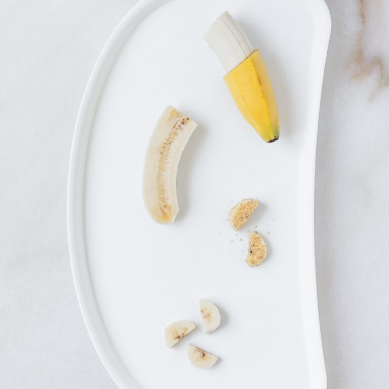 white baby tray with four ways of serving banana for baby led weaning.