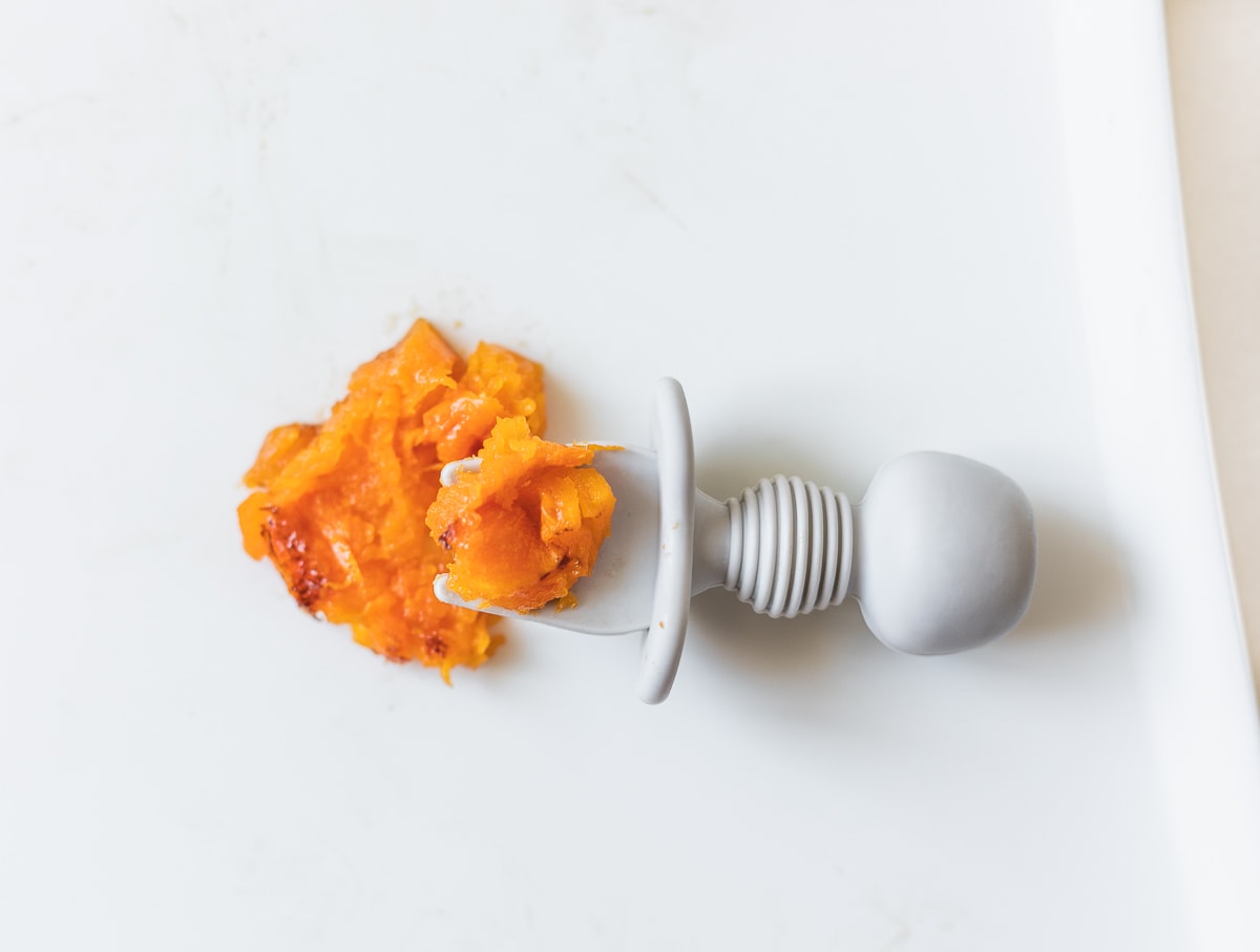 mashed butternut squash on a baby fork.