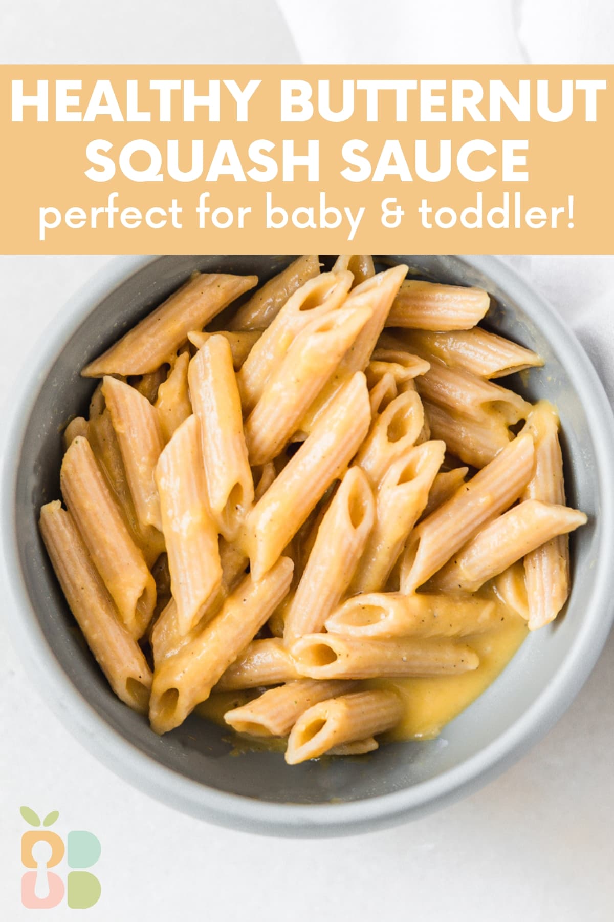 baby bowl of penne pasta with butternut squash pasta sauce with text overlay.