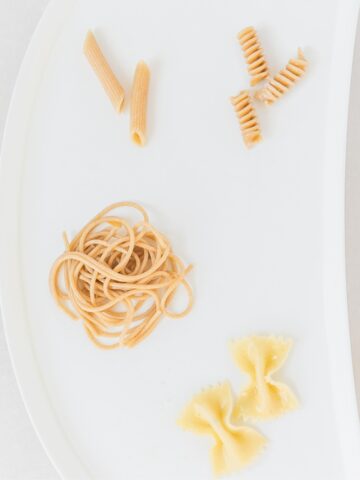 baby tray with several types of noodles on it.