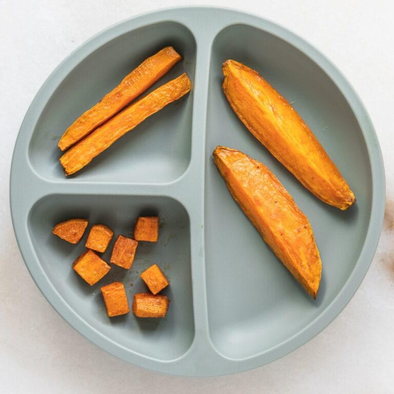 divided baby plate with roasted sweet potato sticks, wedges and cubes on it.