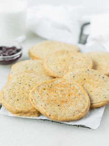 baby quinoa pancakes spread on a rectangular tray.
