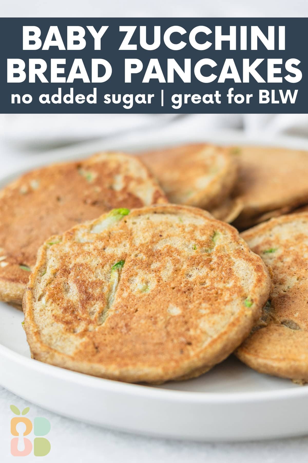 plate of baby zucchini bread pancakes with text overlay.