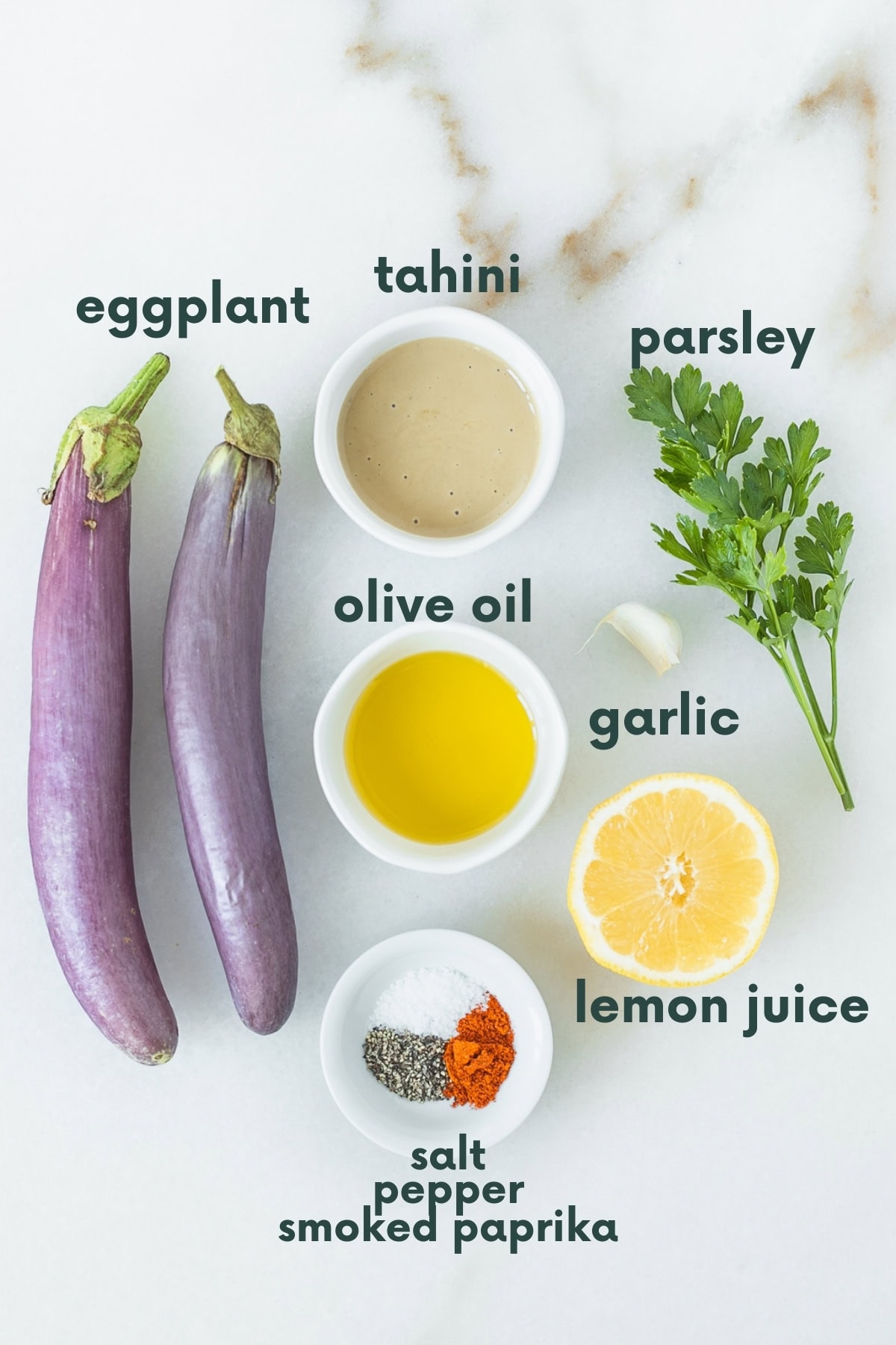 ingredients needed to make babaganoush on a white marble background with text overlay.