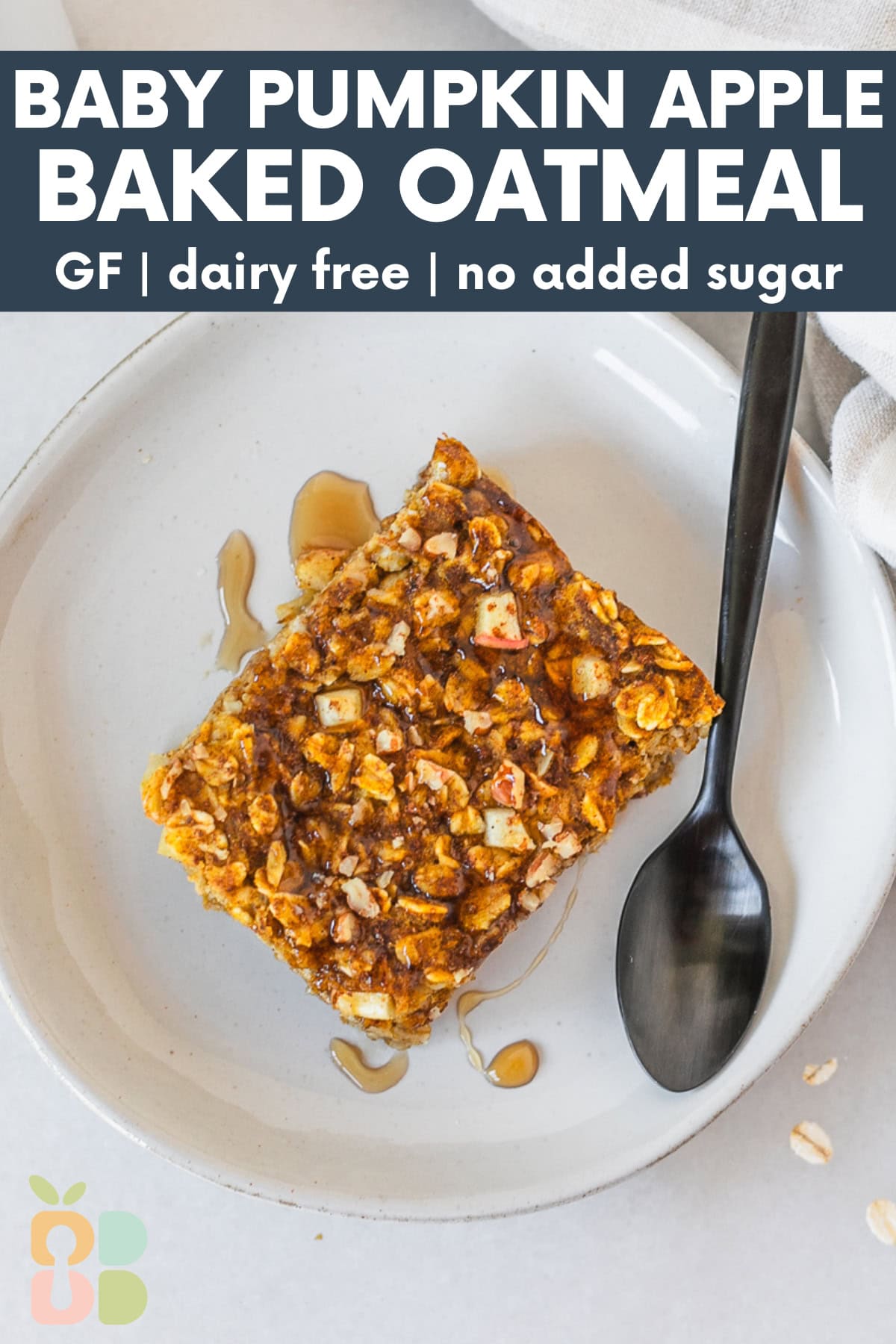square of pumpkin apple baked oatmeal on a small plate with a black spoon with text overlay.