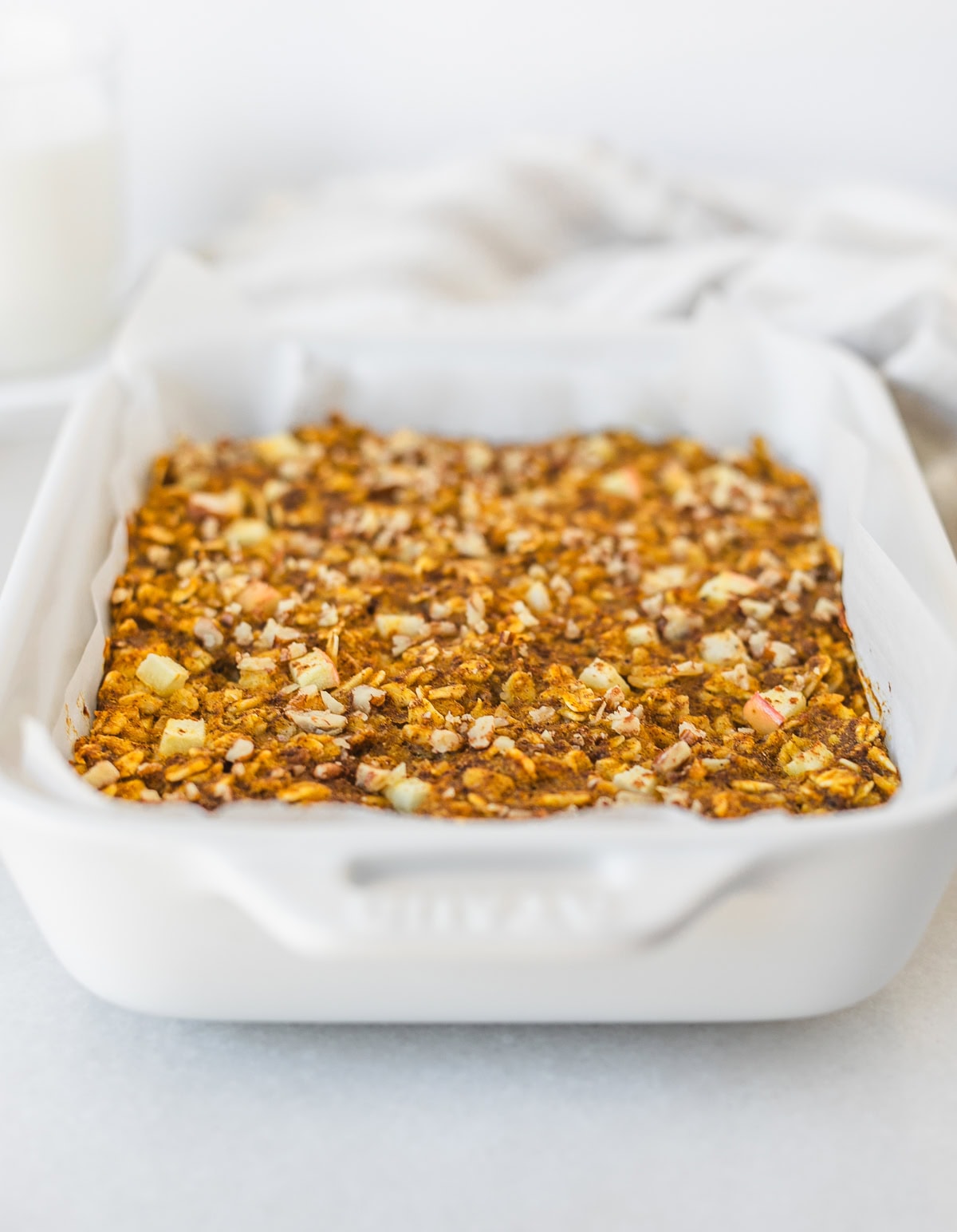 apple pumpkin baked oatmeal in a white baking dish.