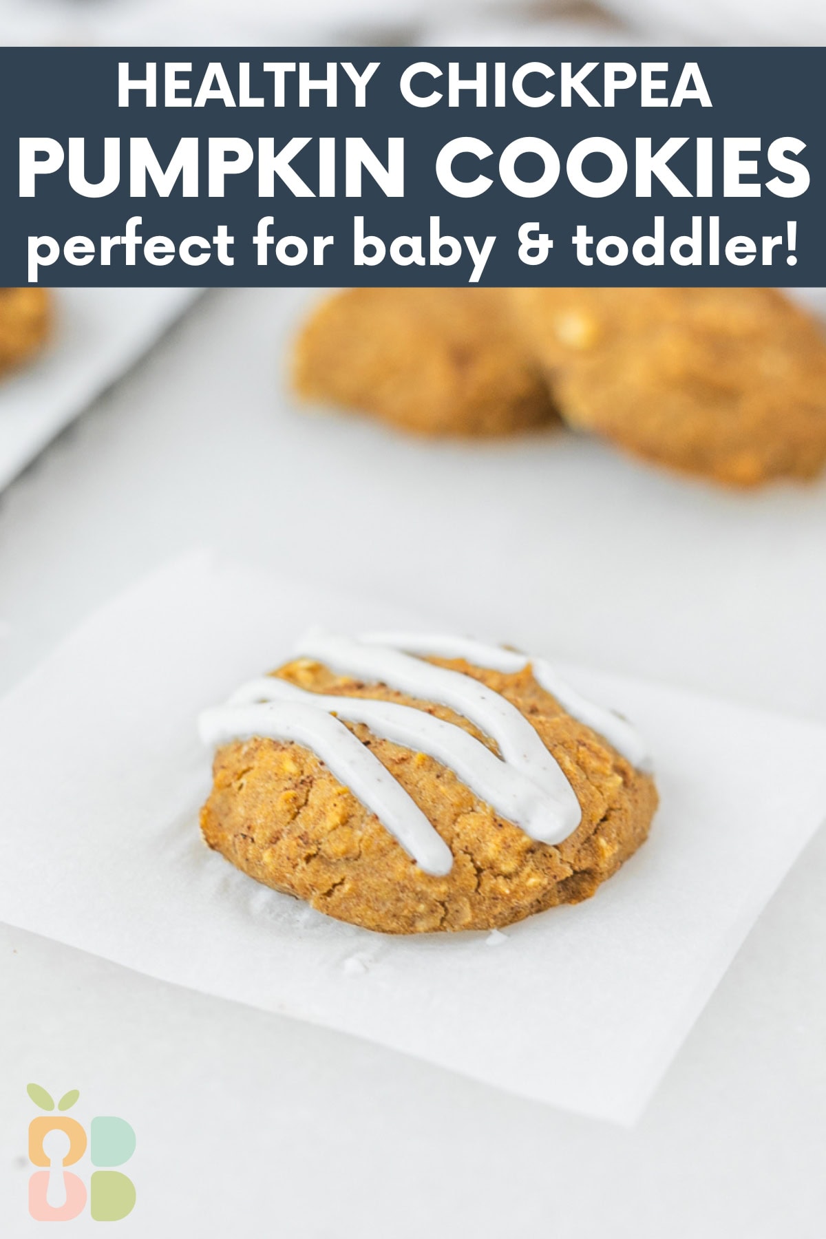baby pumpkin chickpea cookie with yogurt drizzle on a square of parchment with text overlay.
