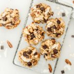 5 dairy free coconut pecan chocolate chip lactation cookies on a wire rack.