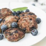 blueberry turkey sausage patties on a plate with blueberries.