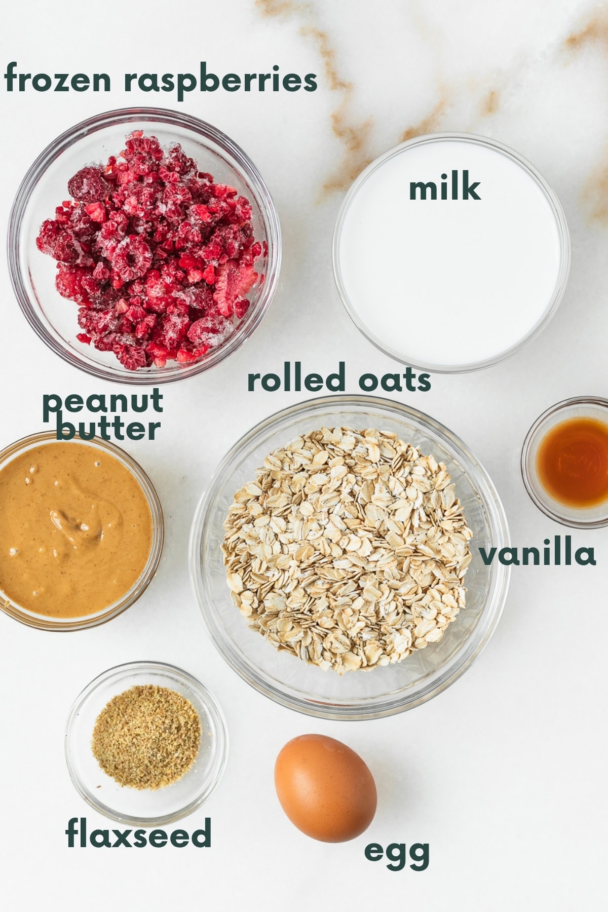 overhead view of ingredients needed to make no sugar PBJ oatmeal bars in bowls with text overlay.