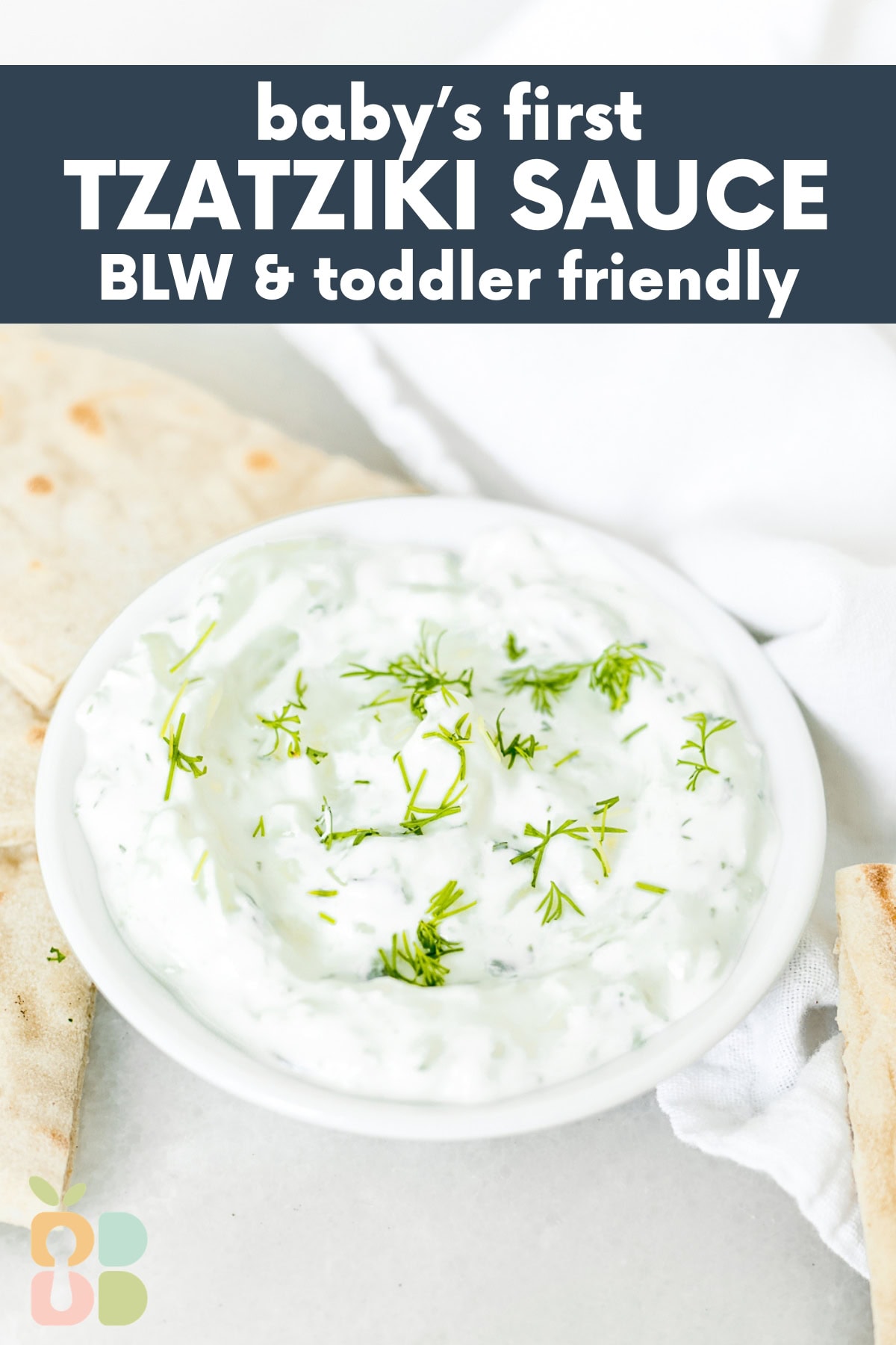 small white bowl of tzatziki sauce with pita wedges and a white napkin with text overlay.